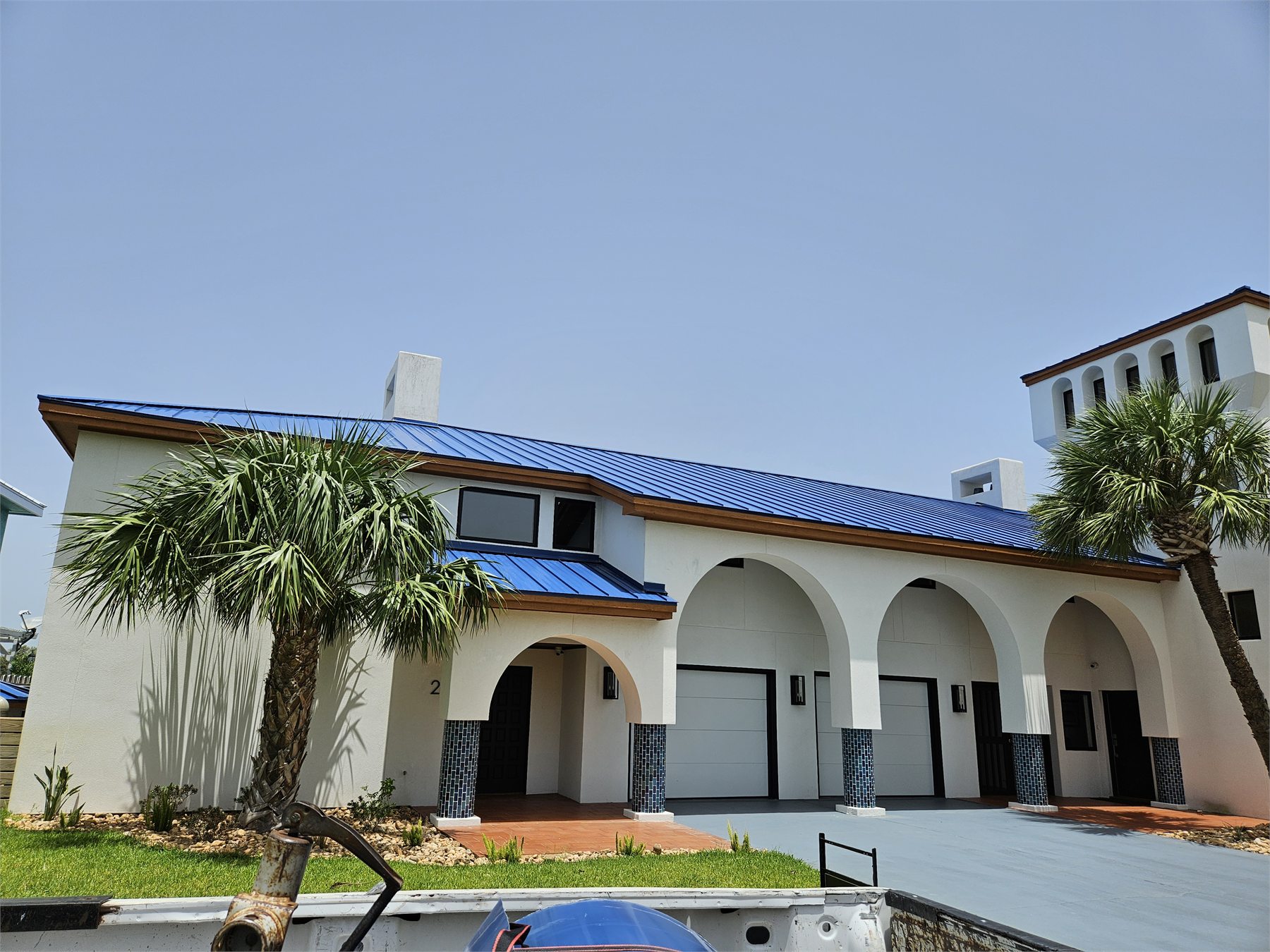 Royal blue metal roof on a distinctive home