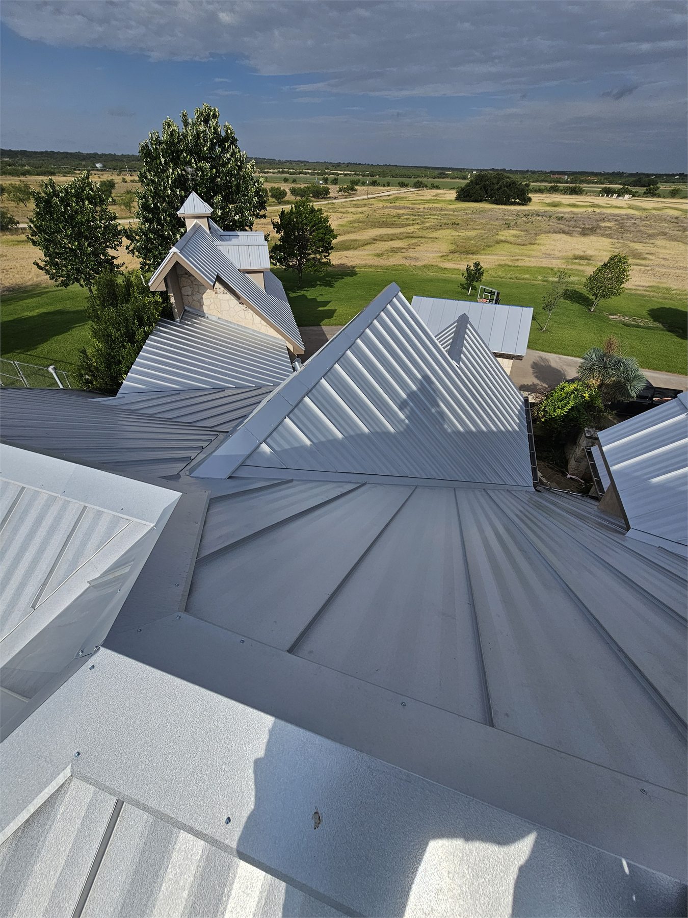 Metal panels fitted across complex roof planes