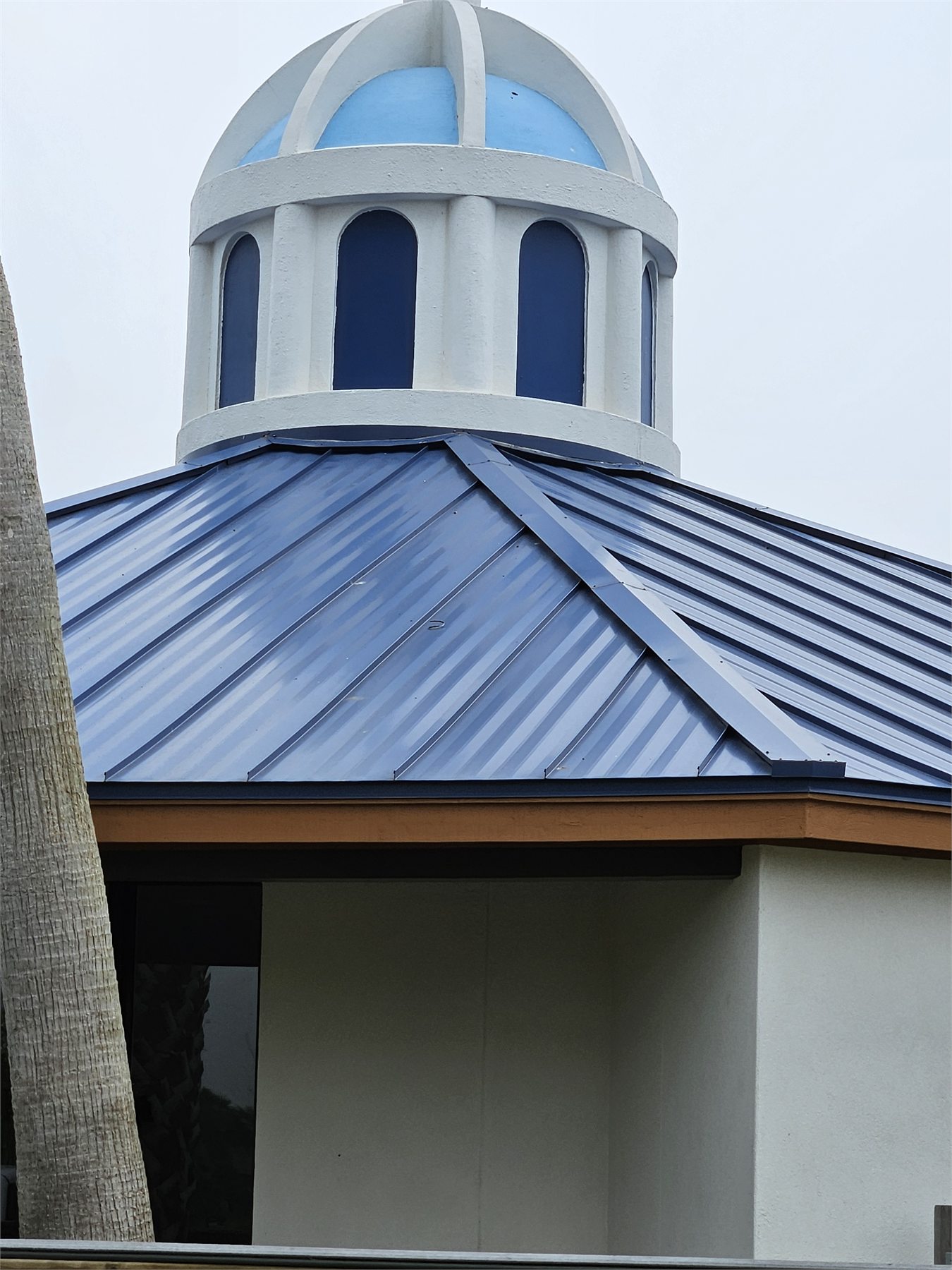 Dark metal roofing around an architectural cupola