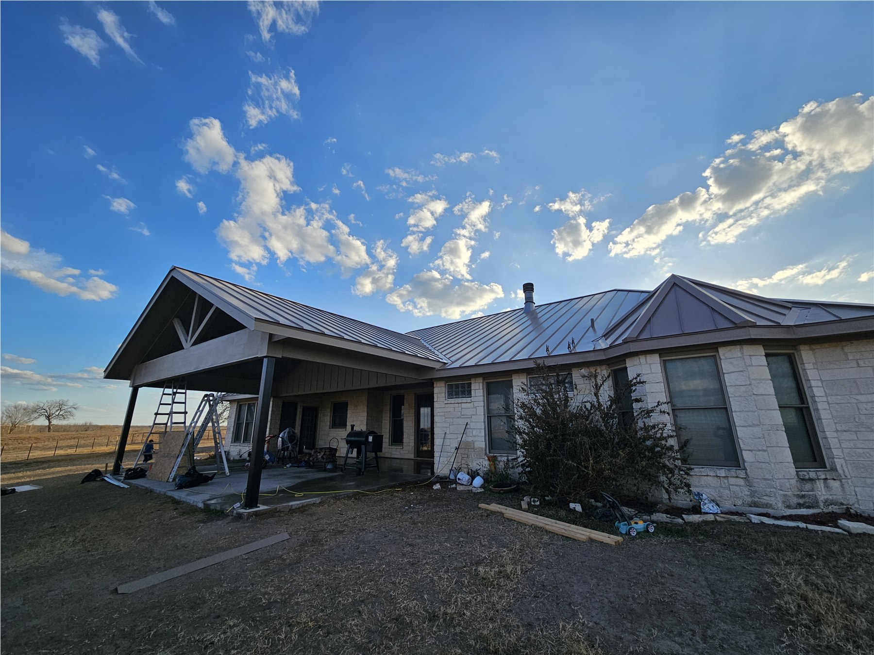 Galvalume double-lock standing seam metal roof on a large stone home