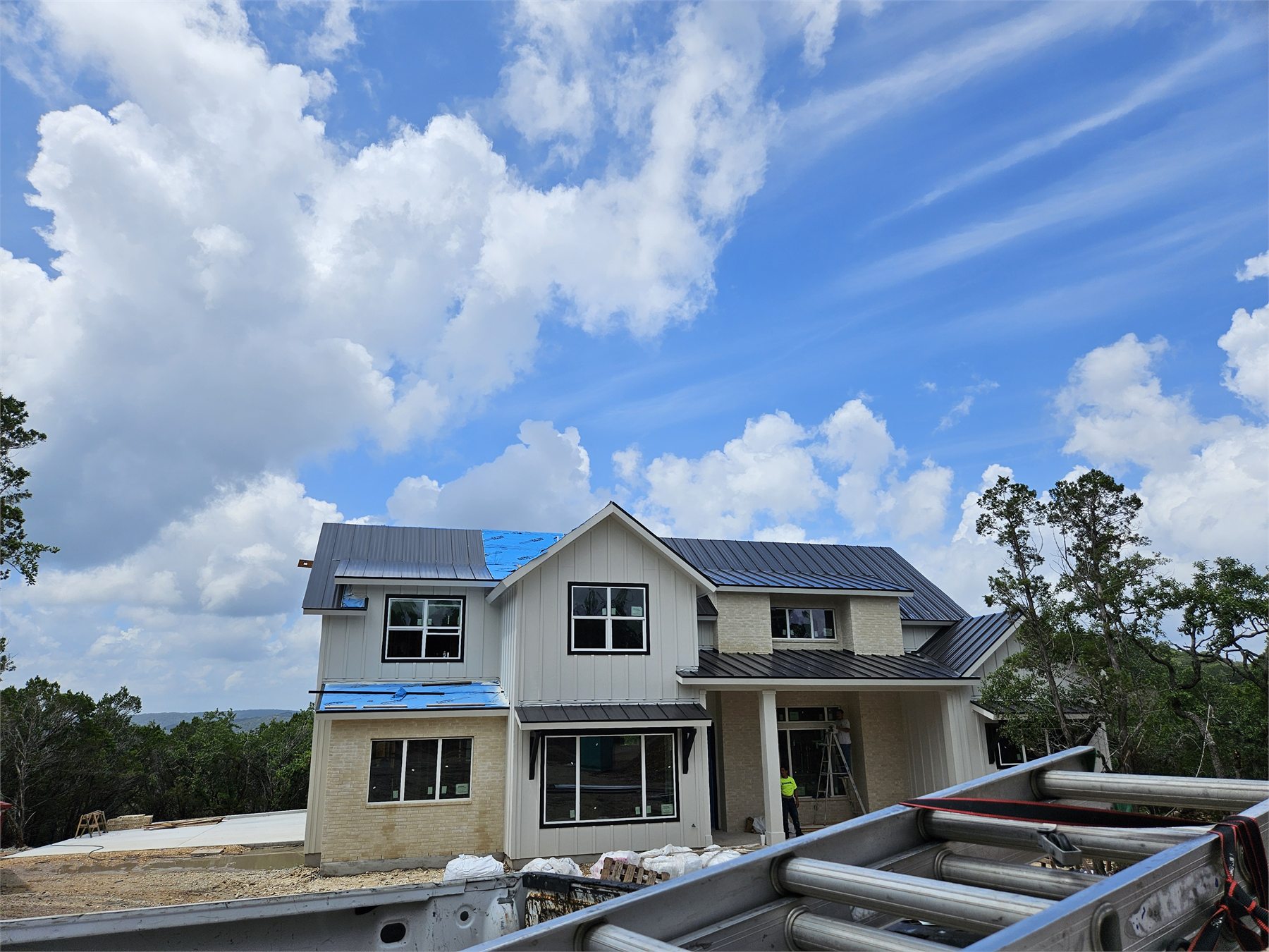 Standing-seam metal roof installation in progress on a residential project