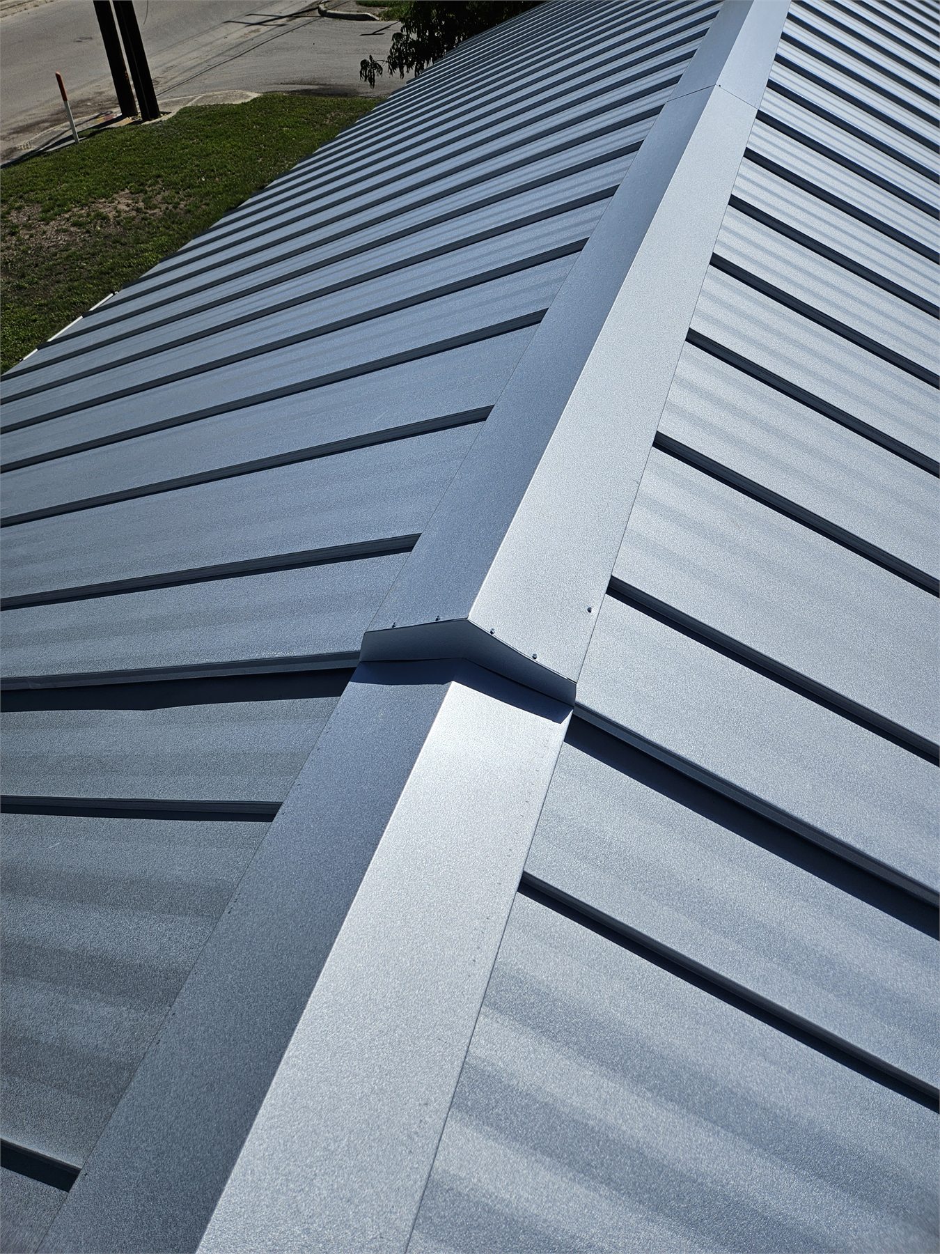 Close view of clean standing-seam metal roof panels and trim